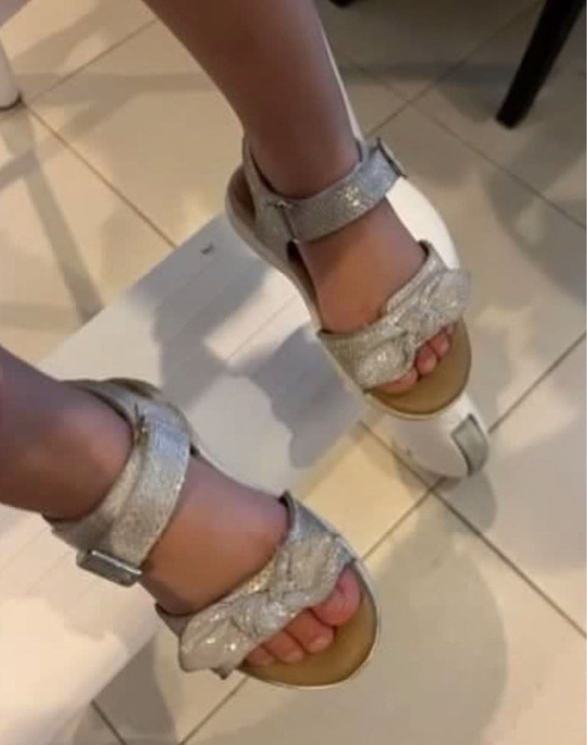 Stride Rite Sandals Size US 7 (Category: Babies & Kids Fashion) located in Manila. Submitted by minkss (Listing ID 1468299045, Image 2). Description: - Brand: Stride Rite SR Whitney - Color/Style: Metallic textured off-white with cute bow detail - Size: US 7M / UK 6 / EU 23 - Features: Adjustable ankle strap with buckle closure, comfortable leather-lined interior - Condition: Clean footbeds, soles show minor wear from gentle use - Ideal for: Ever