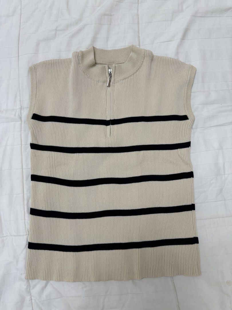 Striped Half Zip Sleeveless Knit Top (Category: Sleeveless) located in Quezon City. Submitted by m3gan8 (Listing ID 1468380137, Image 1). Description: - Color & Pattern: Beige with classic black horizontal stripes - Material: Thick, high-quality ribbed knit texture - Design: Sleeveless with a high ribbed neckline and silver half-zipper front - Fit: Comfortable, flattering cut with a clean bottom hem - Condition: Excellent, well-maintained - Mode 