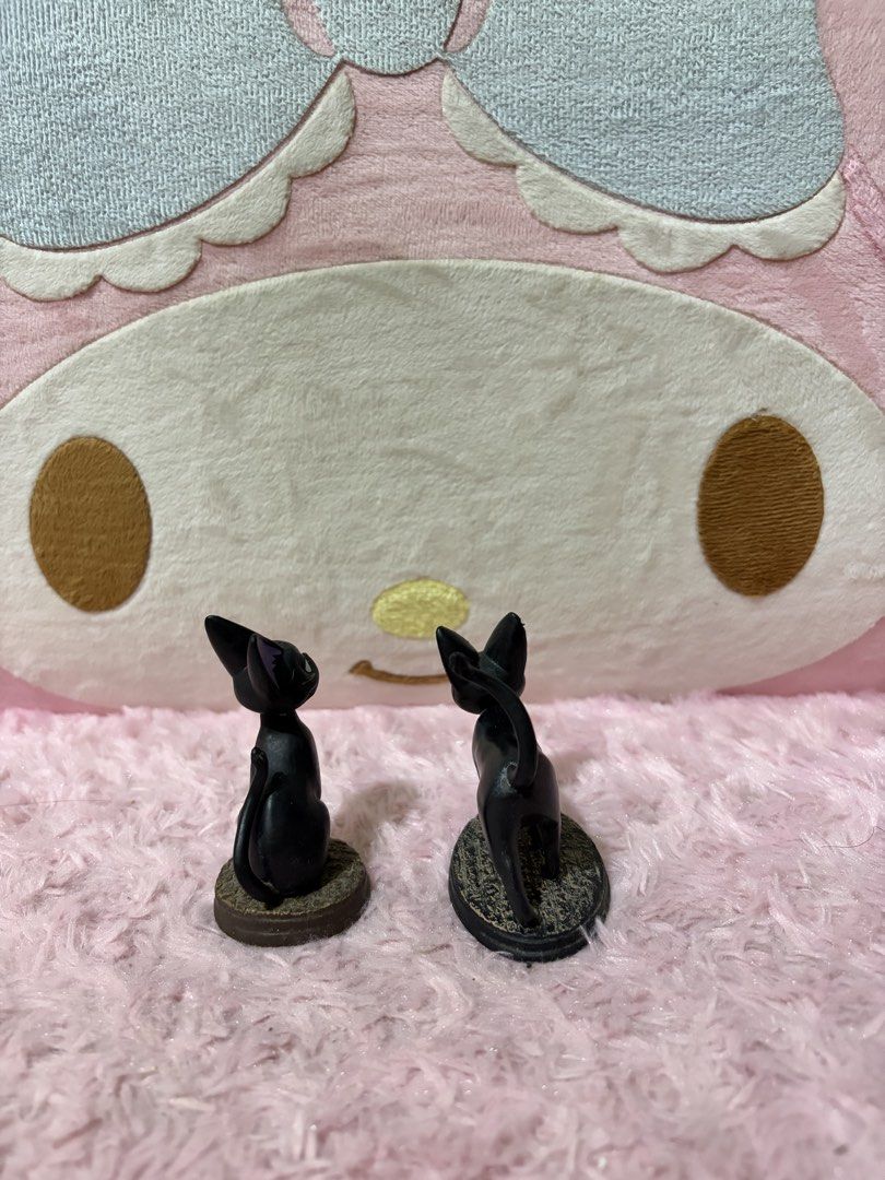 Studio Ghibli Jiji Cat Figures (Category: Figurines & Statues) located in Naic. Submitted by rmcollectibles (Listing ID 1468438181, Image 2). Description: - Authentic Studio Ghibli Jiji figurines (set of 2) - Includes one sitting Jiji and one walking Jiji with tail up - Features cute purple inner ears and detailed textured bases - Official stamp located on the bottom of each stand - Perfect size for a desk display or collection.