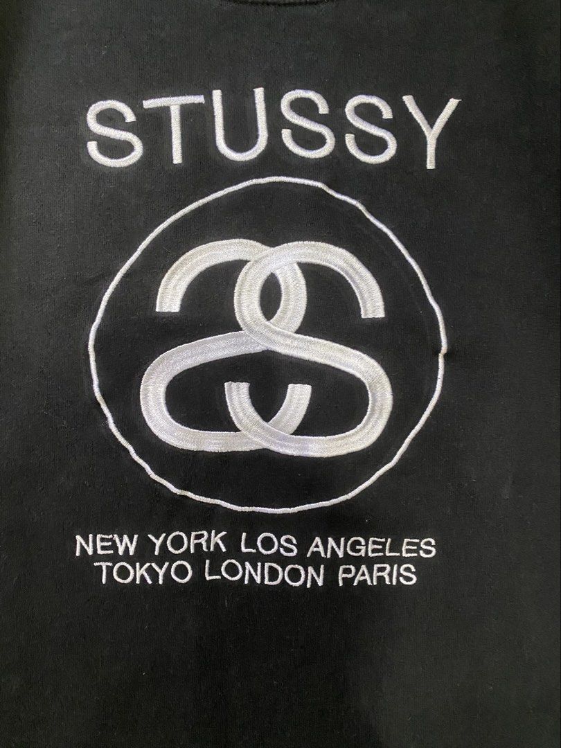 Vintage Stussy Embroidered sweater (Category: Coats, Jackets and Outerwear) located in Antipolo. Submitted by switchneighborhood (Listing ID 1468294901, Image 2). Description: - Brand: Stussy - Style: World Tour Crewneck Sweatshirt - Color: Classic Black - Size: Large (L) - Material: 80% Cotton, 20% Polyester blend - Details: Front embroidered World Tour graphics (NYC, LA, Tokyo, London, Paris), ribbed collar, cuffs, and hem - Condition: Clean, e