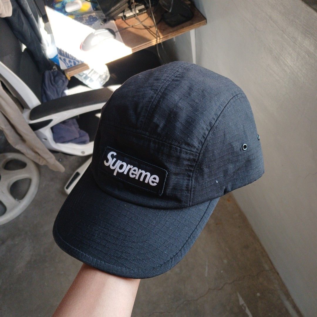 Supreme 5 panel Camp Cap (Category: Caps & Hats) located in Manila. Submitted by joefrey12 (Listing ID 1468334461, Image 2). Description: - Brand: Supreme - Style: Ripstop Camp Cap - Color: Classic Black - Details: Iconic box logo patch on front, adjustable strap closure with plastic buckle, interior US flag tag (Made in U.S.A.) - Condition: Clean structure, minimal wear overall - Perfect for daily streetwear rotation.