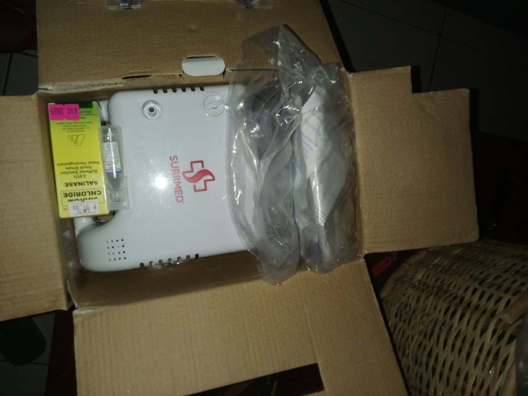 Surrmed Nebulizer Machine with Accessories and Salinase Drops (Category: Medical Supplies & Tools) located in Manila. Submitted by chicoko.26 (Listing ID 1468460303, Image 1). Description: - Brand: Surrmed - Condition: Like new in original cardboard box - Includes: Motor unit (white with red logo), tubing, and mask attachments - Bonus: Unopened accessories wrapped in plastic + sealed box of Salinase Sodium Chloride nasal drops - Clean, securely s