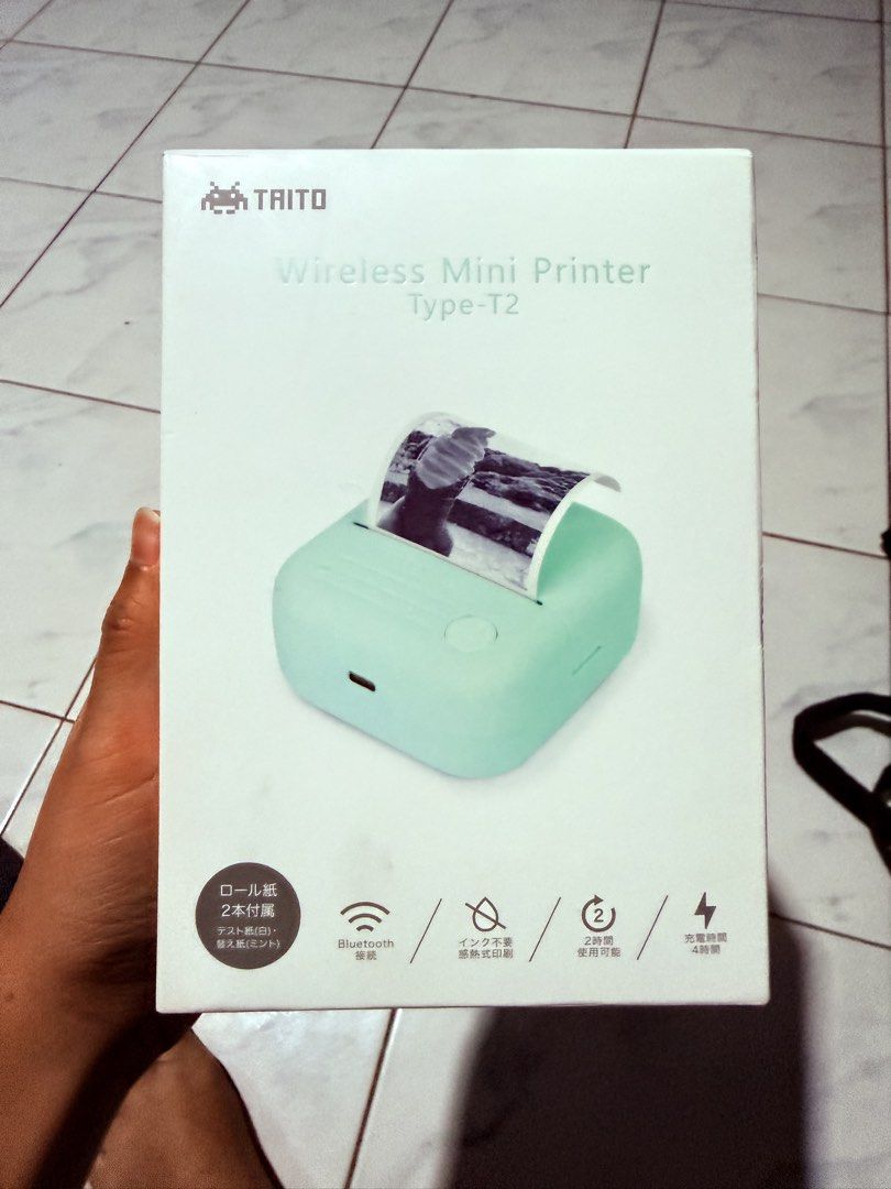 TAITO Wireless Mini Printer Type-T2 Mint Green (Category: Printers, Scanners & Copiers) located in Manila. Submitted by preownedbyyas (Listing ID 1468419985, Image 2). Description: - Brand/Model: TAITO Wireless Mini Printer Type-T2 - Color: Mint Green - Print Technology: Thermal printing (no ink needed) - Connectivity: Bluetooth - Resolution: 200dpi - Weight: Lightweight at 146 grams - Battery: USB rechargeable (approx. 4 hours full charge) - Inc