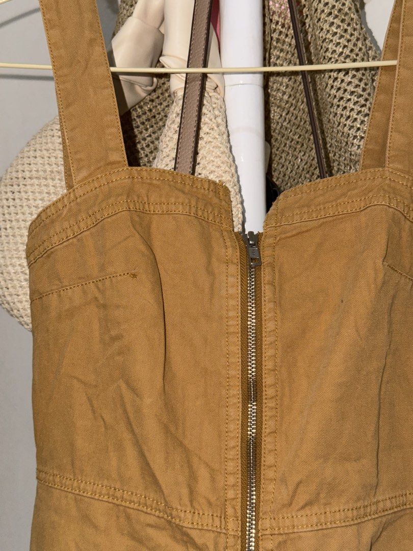 Tan Front Zip Denim Dress (Category: Dresses) located in Taguig. Submitted by deguzmanke83356 (Listing ID 1468344230, Image 2). Description: - Style: Tan overall denim dress with a structured utility look - Details: Thick straps, full-length front zipper, functional front pockets, and stylish paneled stitching - Color: Versatile earthy tone - Styling Tip: Easy to layer over your favorite t-shirts or turtlenecks for a cute casual outfit - Conditio