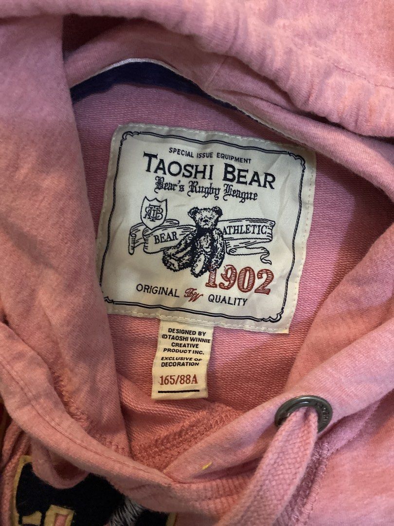Taoshi Bear Pink Pullover Hoodie Size 165/88A (Category: Coats, Jackets and Outerwear) located in Manila. Submitted by newkkmora98454 (Listing ID 1468316029, Image 3). Description: - Color/Brand: Pink Taoshi Bear hoodie - Design: Cute bear patch with 'Bear 1902' lettering on the front - Features: Adjustable drawstring hood and front kangaroo pocket - Material: Soft, warm, and comfortable - Size: 165/88A tag inside .
