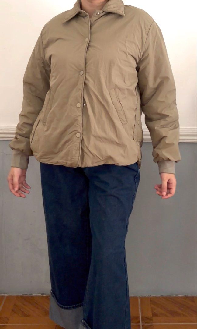 Taupe Fleece Bomber Jacket (unisex) (Category: Coats, Jackets and Outerwear) located in San Fernando. Submitted by akcd12 (Listing ID 1468342225, Image 3). Description: What you see is what you get ✨ Fits - med to large body frame for women or small body frame for men Stylish taupe/beige puffer jacket with a classic collar, button-front closure, long sleeves, and elasticated cuffs. Minor flaw: Faint discoloration/stain on the jacket fabric near t