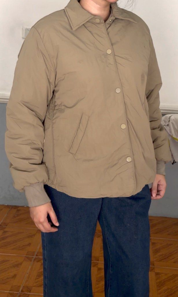 Taupe Fleece Bomber Jacket (unisex) (Category: Coats, Jackets and Outerwear) located in San Fernando. Submitted by akcd12 (Listing ID 1468342225, Image 2). Description: What you see is what you get ✨ Fits - med to large body frame for women or small body frame for men Stylish taupe/beige puffer jacket with a classic collar, button-front closure, long sleeves, and elasticated cuffs. Minor flaw: Faint discoloration/stain on the jacket fabric near t