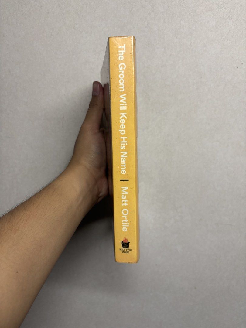 The Groom Will Keep His Name by Matt Ortile (Category: Storybooks) located in Cabuyao City. Submitted by john.sellsthings (Listing ID 1468396229, Image 2). Description: Paperback copy of The Groom Will Keep His Name by Matt Ortile. Published by Bold Type Books. Collection of essays about race, resistance, romance, and navigating life as a gay Filipino immigrant in America. Pages have foxing and yellowing spots from age. Cover shows minor shelf we