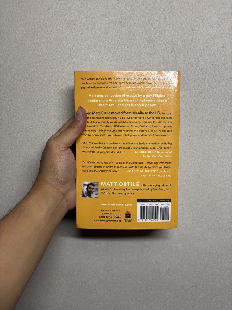 The Groom Will Keep His Name by Matt Ortile (Category: Storybooks) located in Cabuyao City. Submitted by john.sellsthings (Listing ID 1468396229, Image 3). Description: Paperback copy of The Groom Will Keep His Name by Matt Ortile. Published by Bold Type Books. Collection of essays about race, resistance, romance, and navigating life as a gay Filipino immigrant in America. Pages have foxing and yellowing spots from age. Cover shows minor shelf we