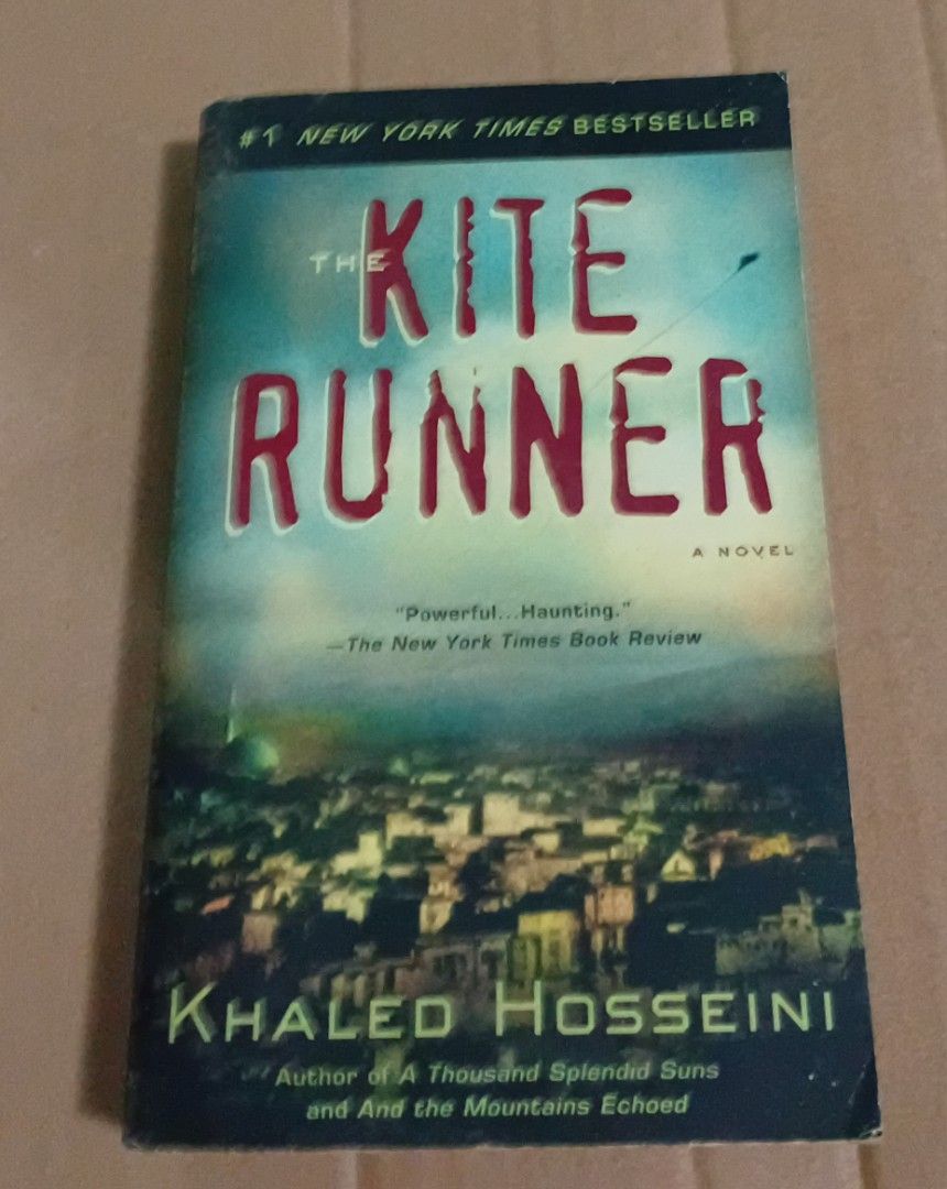 The Kite Runner by Khaled Hosseini Novel (Category: Storybooks) located in Manila. Submitted by luckyfox-3a3e (Listing ID 1468448980, Image 1). Description: - Title: The Kite Runner - Author: Khaled Hosseini (#1 New York Times bestseller) - Format: Standard paperback with striking cityscape cover and red typography - Condition/Details: Great read with original barcode sticker on the back cover - Perfect for: Book clubs, fiction fans, and book col