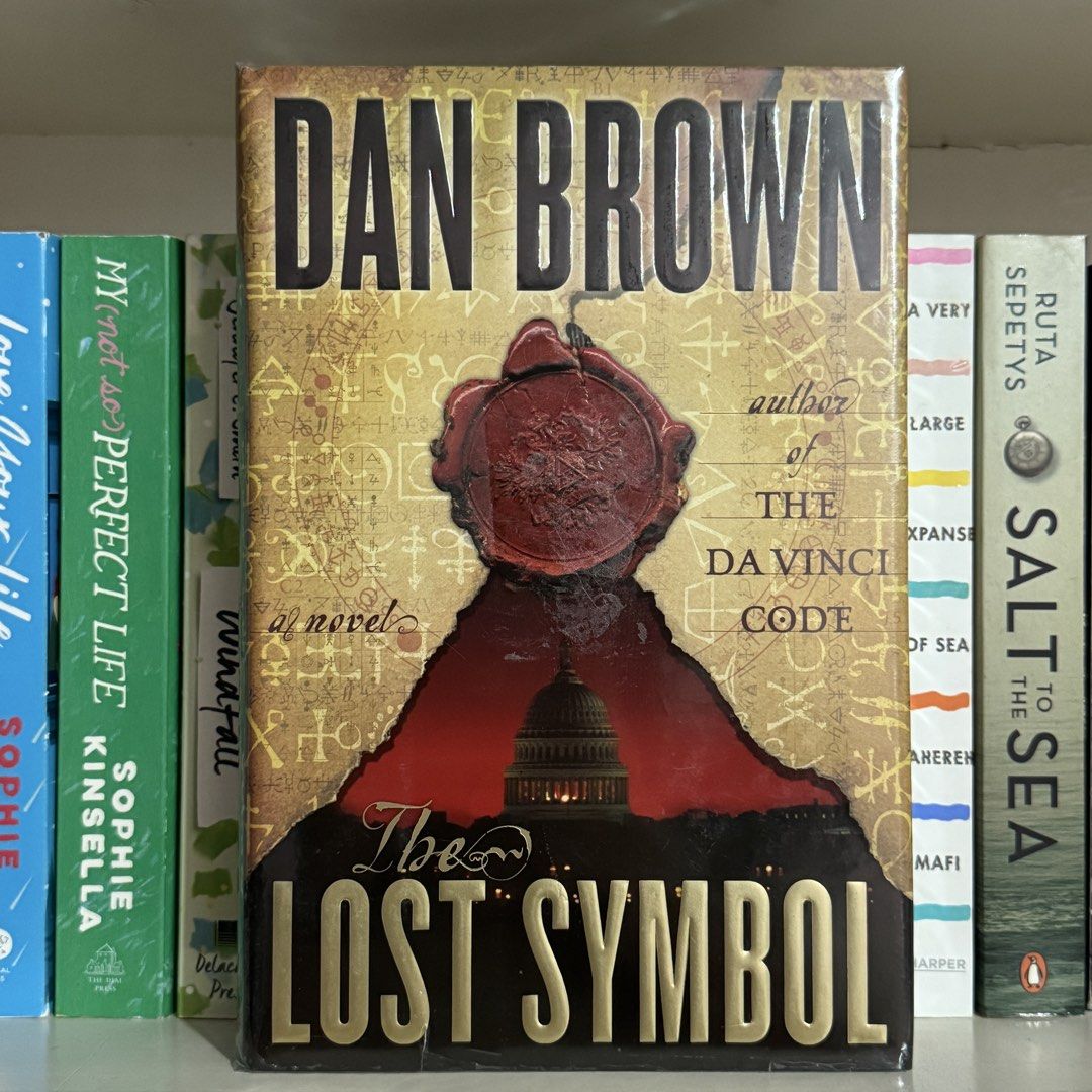 The Lost Symbol by Dan Brown (Hardcover) (Category: Storybooks) located in General Santos City (Dadiangas). Submitted by forgottenreader (Listing ID 1468284618, Image 1). Description: - Title: The Lost Symbol by Dan Brown - Format: Hardcover with dust jacket - In good condition, but with yellow tanning, wrapped in protective plastic for extra care You may send me a direct message here or to my IG account - @forgottenreader - for fast transaction 