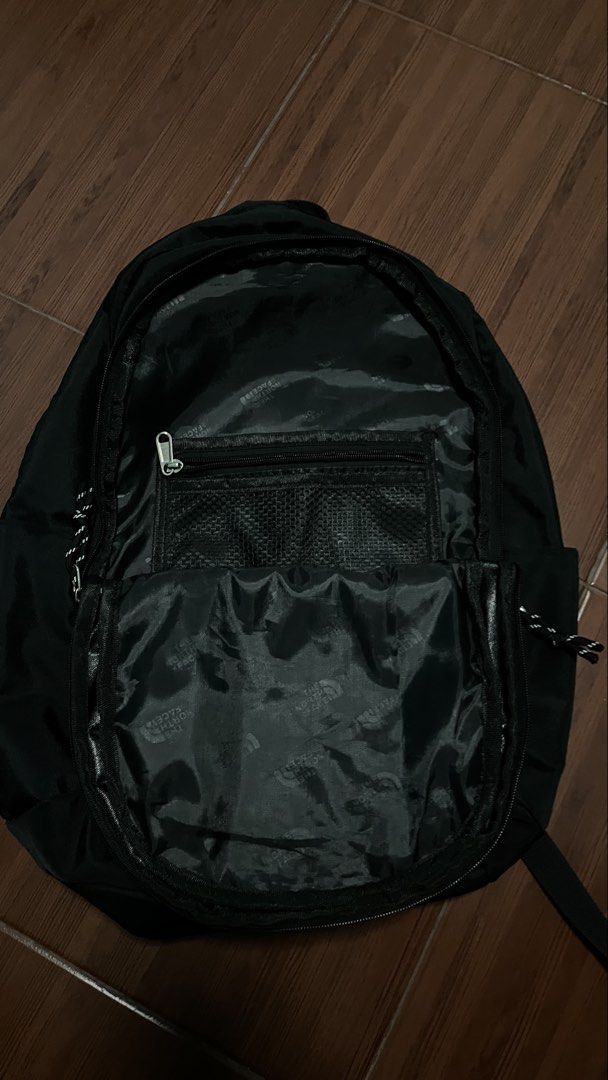 The North Face Black Backpack (Category: Backpacks) located in Manila. Submitted by cansitcanton (Listing ID 1468418817, Image 3). Description: - Brand: The North Face - Color: Classic Black - Condition: Clean inside and out, zippers work smoothly - Storage: Multiple compartments with built-in laptop sleeve and interior mesh zipper pocket - Exterior: Practical front bungee cords - Comfort: Padded shoulder straps with sternum strap and embossed su