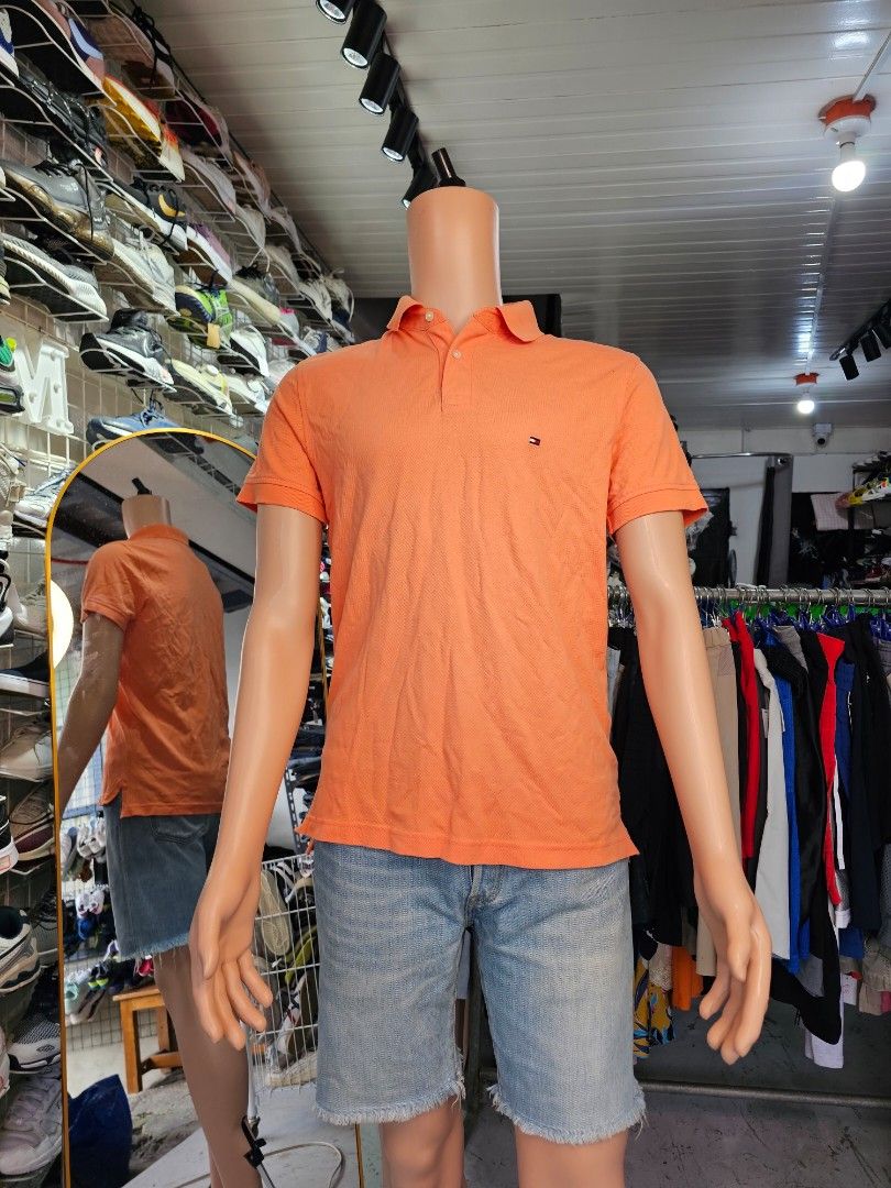 the Tommy Hilfiger 1985 Regular Fit Polo. (Category: Tshirts & Polo Shirts ) located in Baguio. Submitted by kayeonlineshop (Listing ID 1468343776, Image 1). Description: orange Tommy Hilfiger men's polo shirt.