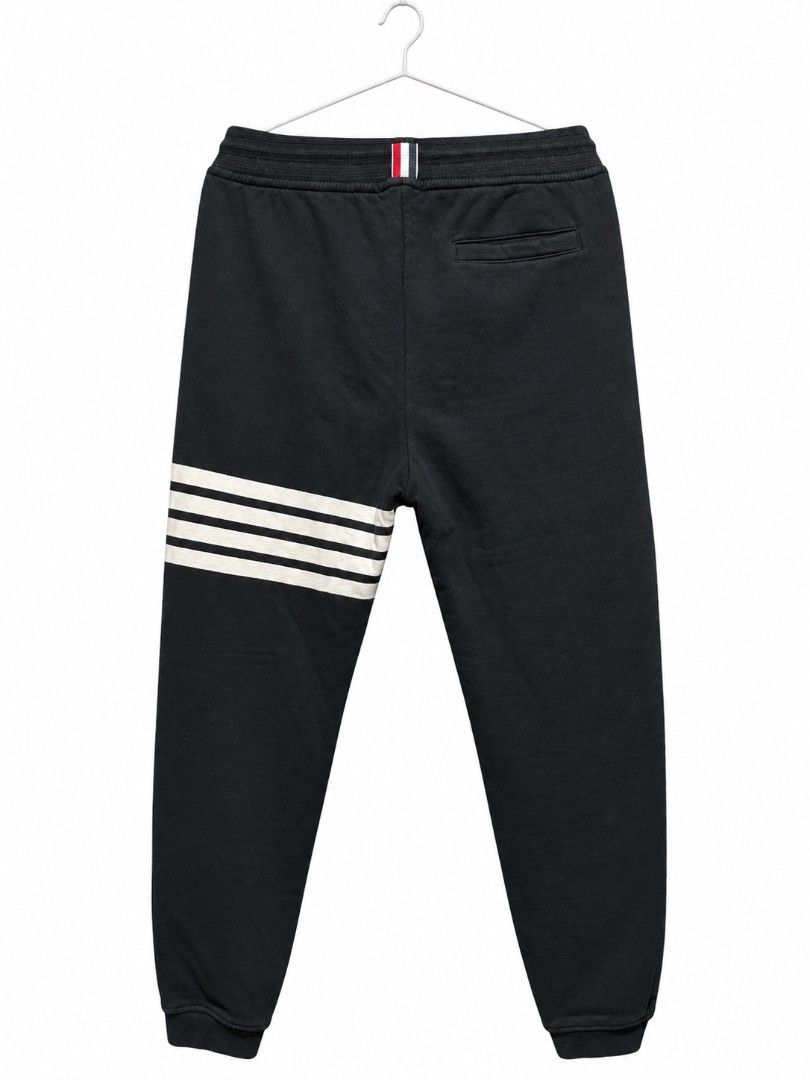 Thom Browne Sweatpants (Category: Joggers) located in Bulacan. Submitted by ukaybrandedshop (Listing ID 1468351725, Image 2). Description: Thom Browne 4-Bar Sweatpants - MADE IN ITALY - Navy Size 3 Fits 32-34 | W 32-34 | L 40.5 | LO 6 Condition 9/10 - Colorate 9.5 No butas, garter goods, complete tags Issue: minimal stain sa white bar only (washable) Details: RWB tab, metal aglet, 4-bar, hem tag, washtag Made in Italy - 100% Authentic ₱1,500 + SF