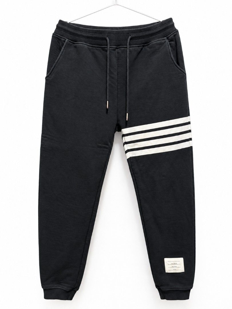 Thom Browne Sweatpants (Category: Joggers) located in Bulacan. Submitted by ukaybrandedshop (Listing ID 1468351725, Image 1). Description: Thom Browne 4-Bar Sweatpants - MADE IN ITALY - Navy Size 3 Fits 32-34 | W 32-34 | L 40.5 | LO 6 Condition 9/10 - Colorate 9.5 No butas, garter goods, complete tags Issue: minimal stain sa white bar only (washable) Details: RWB tab, metal aglet, 4-bar, hem tag, washtag Made in Italy - 100% Authentic ₱1,500 + SF