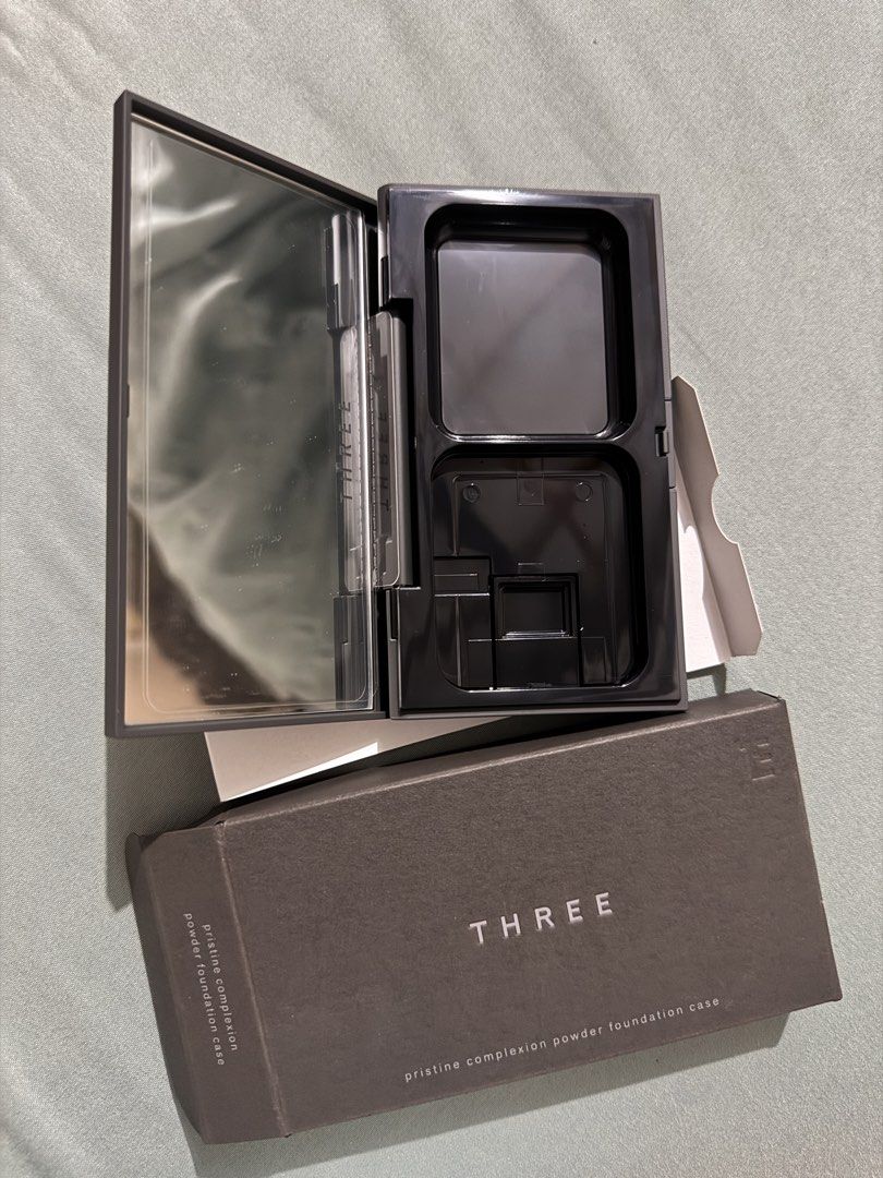 THREE Pristine Compact Case for Powder Foundation (Brand New w/ Box) (Category: Makeup) located in Pili. Submitted by nthlzam (Listing ID 1468420677, Image 2). Description: Authentic THREE Pristine Complexion Powder Foundation Case imported from Japan. Includes mirror and dual compartment design for foundation refill pan and applicator/sponge. Note: Sale includes the empty compact case and box only (refill powder and sponge not included)..