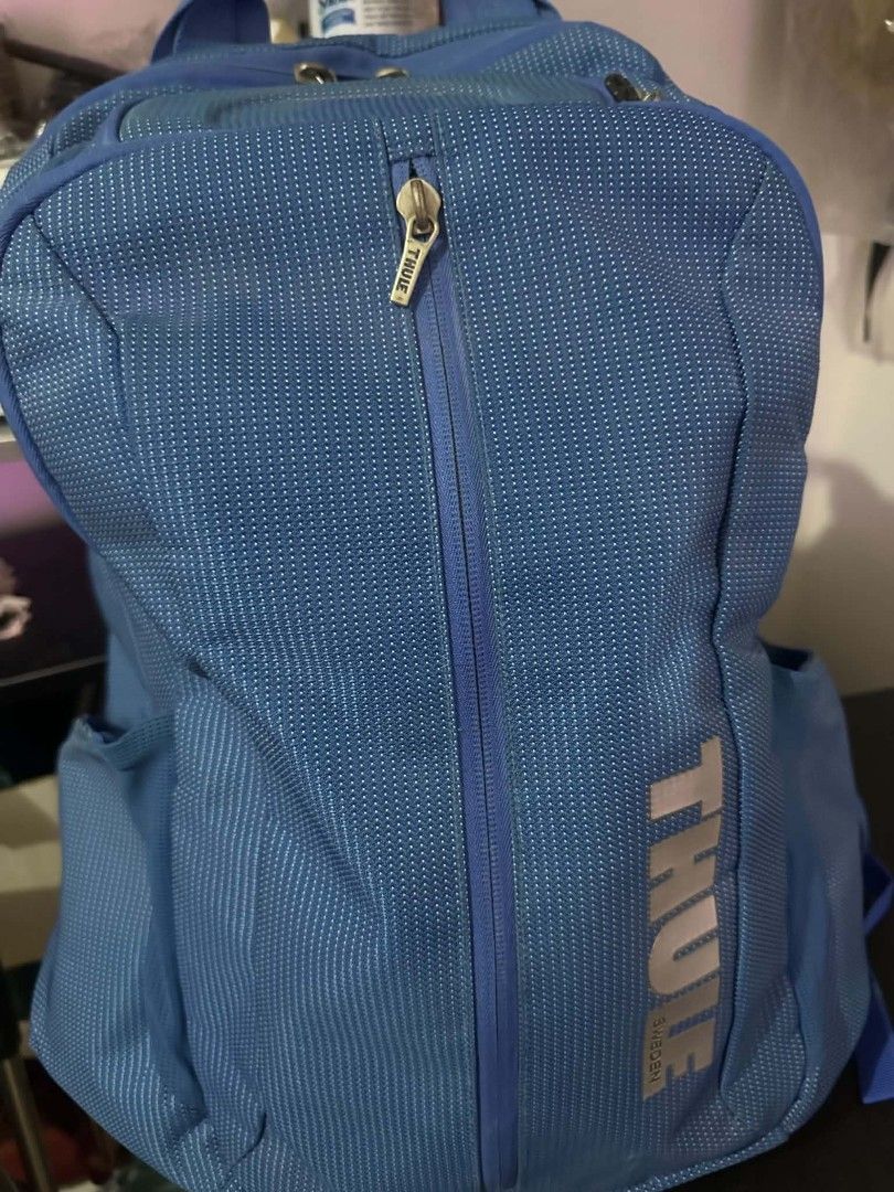 Thule Blue Backpack (Category: Backpacks) located in Las Pinas. Submitted by calmwolf_2a8740 (Listing ID 1468289105, Image 1). Description: - Authentic blue Thule backpack with a unique patterned fabric texture - Ideal for daily school commute, work, or travel - Vertical front zipper pocket for quick access to essentials - Large reflective Thule branding near the base for safety - Padded mesh shoulder straps and adjustable chest buckle strap for 