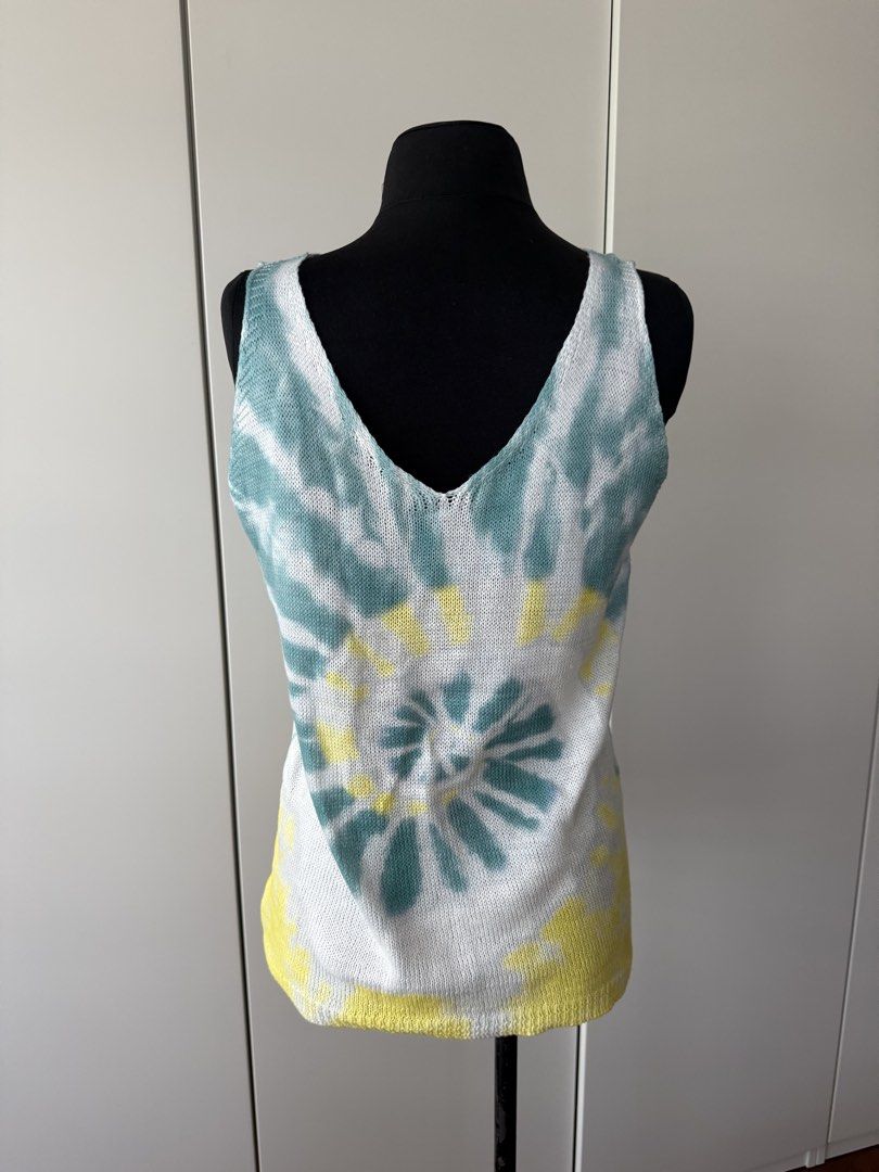 Tie Dye Knit Tank Top Blue Yellow (Category: Sleeveless) located in Manila. Submitted by cristycrab247 (Listing ID 1468388465, Image 2). Description: - Design: Blue, yellow, and white spiral tie-dye pattern - Neckline: Deep V-neck on both front and back - Fabric: Lightweight open-knit, ideal for warm weather and beach days - Fit: Relaxed and comfortable.