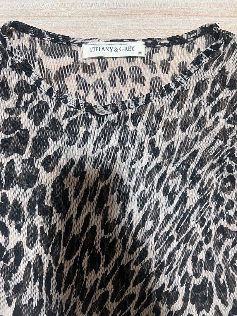 Tiffany & Grey Leopard Print Mesh Dress Size M (Category: Dresses) located in Manila. Submitted by jk2578 (Listing ID 1468308662, Image 2). Description: - Brand: Tiffany & Grey - Style: Leopard print midi dress with long sleeves and round neckline - Material: Sheer, lightweight mesh fabric - Size: Medium (tag attached) - Fit: Flat lay measurements available in photos - Versatility: Great layering piece for casual wear or night outs.