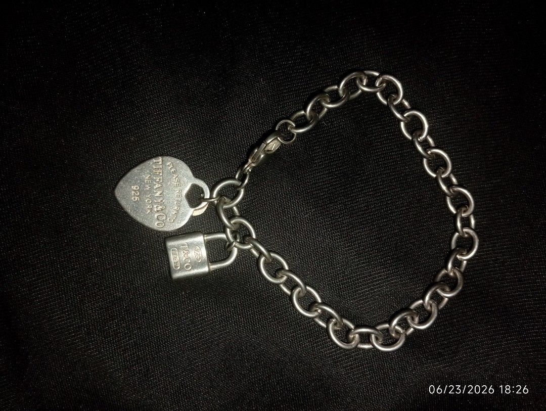 Tiffany Heart Tag Charm Bracelet (Category: Bracelets) located in Puerto Princesa. Submitted by cantfwdricko (Listing ID 1468348602, Image 3). Description: - Brand: Tiffany - Material: Sterling Silver (925 hallmark) - Charms: Return to Tiffany engraved heart tag & T&Co 1837 mini padlock - Closure: Secure lobster clasp - Condition: Classic everyday piece with minor surface hairline scratches from normal wear - Inclusions: Bracelet only.