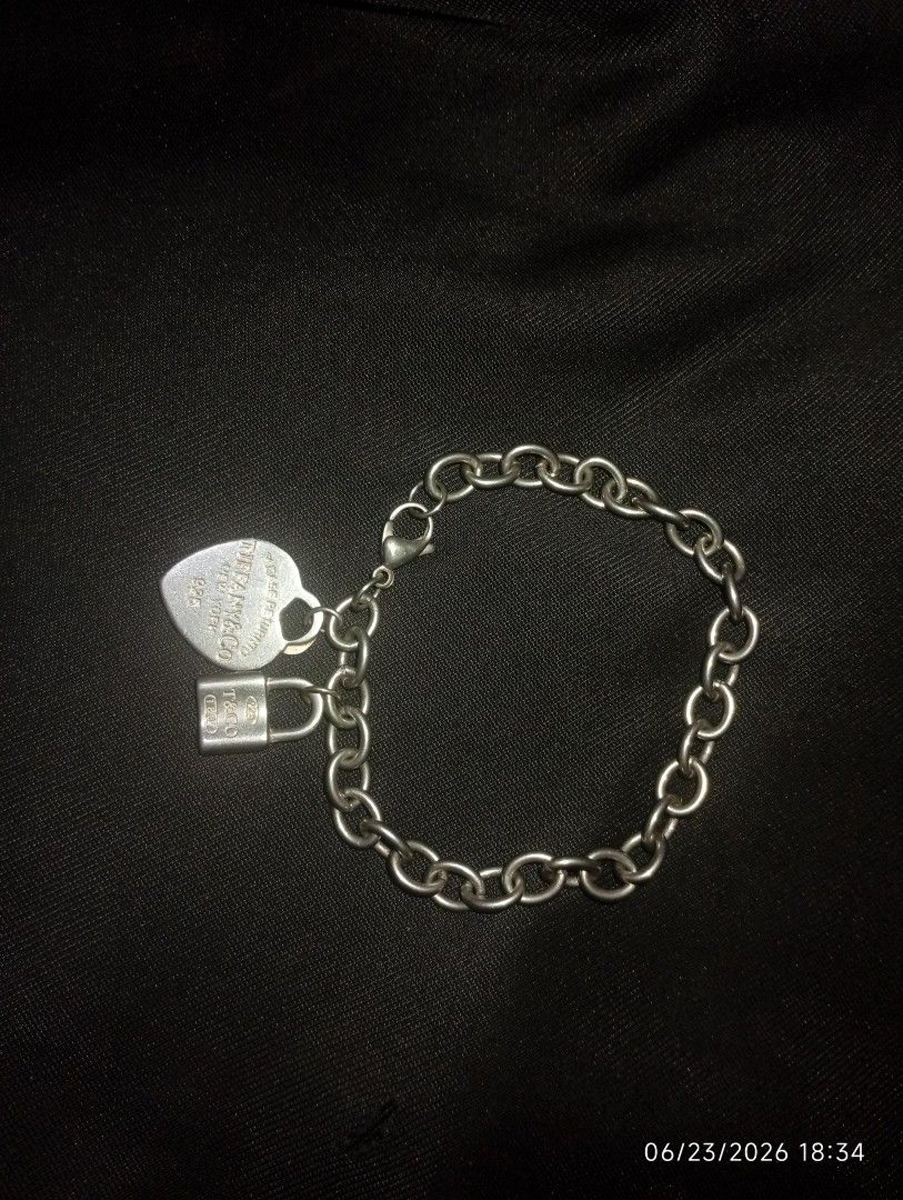 Tiffany Heart Tag Charm Bracelet (Category: Bracelets) located in Puerto Princesa. Submitted by cantfwdricko (Listing ID 1468348602, Image 2). Description: - Brand: Tiffany - Material: Sterling Silver (925 hallmark) - Charms: Return to Tiffany engraved heart tag & T&Co 1837 mini padlock - Closure: Secure lobster clasp - Condition: Classic everyday piece with minor surface hairline scratches from normal wear - Inclusions: Bracelet only.
