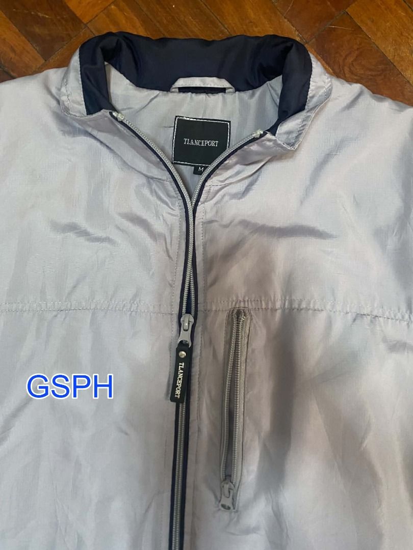 Tlanceport Light Blue Zip-Up Windbreaker Jacket Medium (Category: Coats, Jackets and Outerwear) located in Makati City. Submitted by goodiesstuff_ph_17119811 (Listing ID 1468432085, Image 2). Description: Good to wear on hiking, trekking, Baguio or Tagaytay. - Brand/Model: Tlanceport zip-up jacket - Color: Light grey / light blue - Size: M (tag on collar) - Features: Full front zipper with branded pull tab, vertical chest pocket, lower side pocke