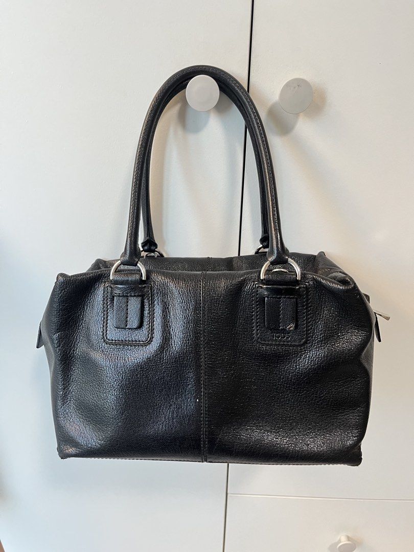 Tod's Black Leather Structured Handbag (Category: Luxury Bags & Wallets) located in Makati City. Submitted by anndeetree (Listing ID 1468362176, Image 1). Description: Tod's black leather handbag with structured design. Double top handles and silver tone hardware. Zip closure across the top with branded zipper pulls. Pebbled texture on the leather. Clean stitching along the front seams and handle mounts..