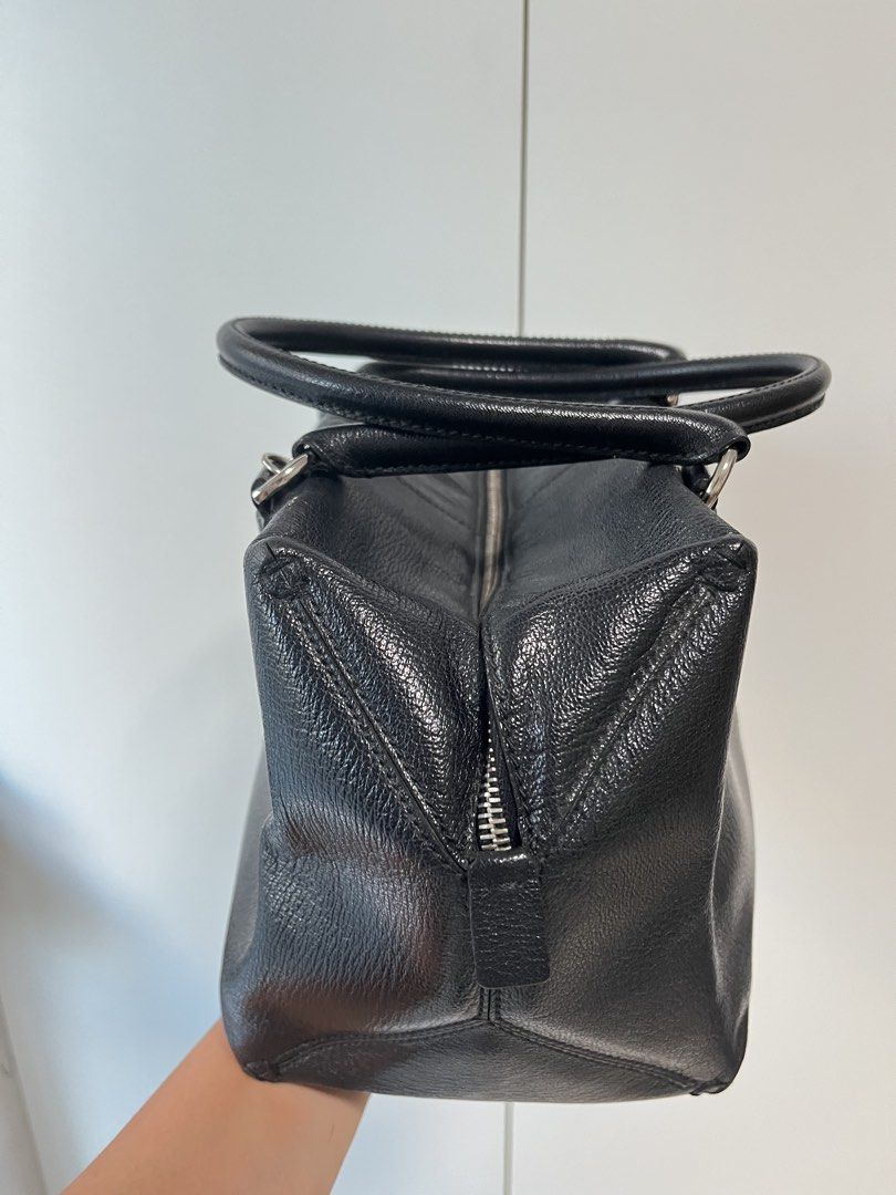 Tod's Black Leather Structured Handbag (Category: Luxury Bags & Wallets) located in Makati City. Submitted by anndeetree (Listing ID 1468362176, Image 3). Description: Tod's black leather handbag with structured design. Double top handles and silver tone hardware. Zip closure across the top with branded zipper pulls. Pebbled texture on the leather. Clean stitching along the front seams and handle mounts..