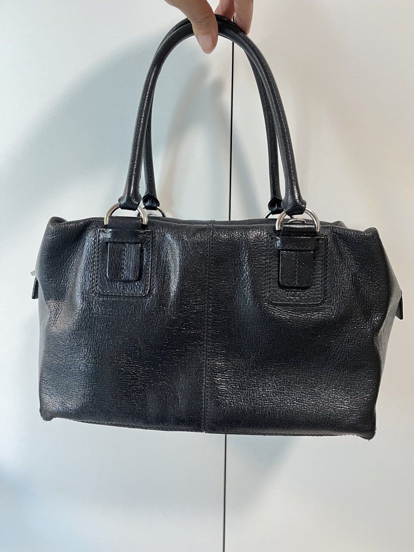 Tod's Black Leather Structured Handbag (Category: Luxury Bags & Wallets) located in Makati City. Submitted by anndeetree (Listing ID 1468362176, Image 2). Description: Tod's black leather handbag with structured design. Double top handles and silver tone hardware. Zip closure across the top with branded zipper pulls. Pebbled texture on the leather. Clean stitching along the front seams and handle mounts..