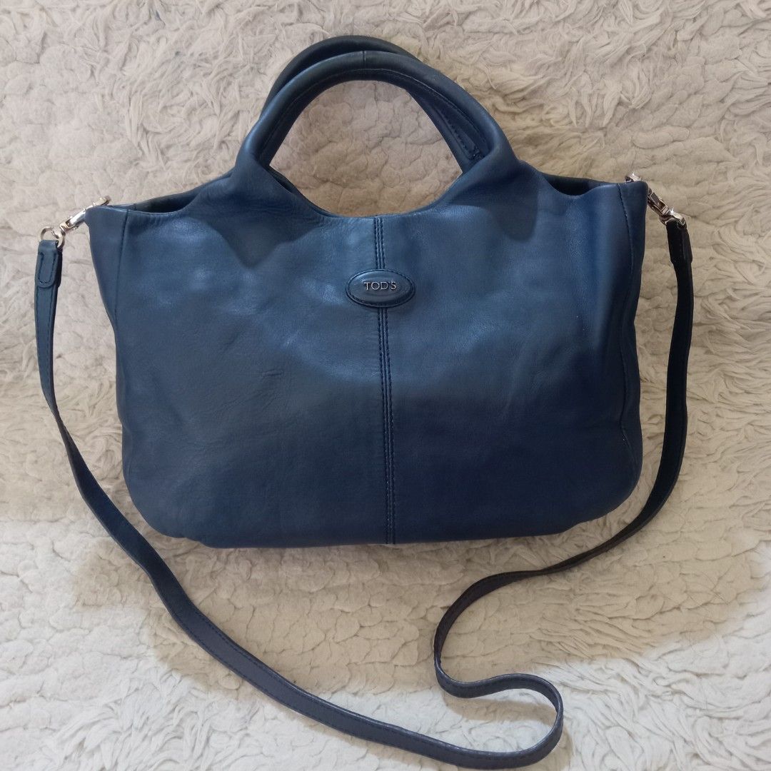 TOD'S Blue Leather Shoulder Bag (Category: Shoulder Bags) located in Baguio. Submitted by sheren_signatures (Listing ID 1468286437, Image 1). Description: - Brand: TOD'S - Color: Dark Blue - Material: Genuine Leather with silver-tone hardware - Straps: Double top handles and a detachable shoulder strap - Closure: Magnetic snap top closure - Interior: TOD'S monogram fabric lining with a zippered pocket - Authenticity: Includes 'Made in Italy', 'Ge