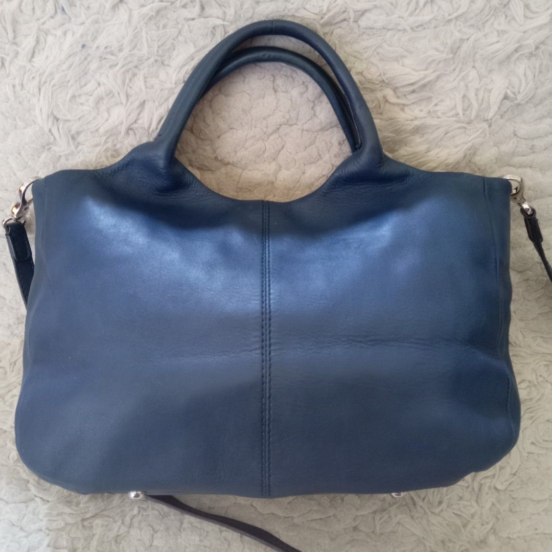 TOD'S Blue Leather Shoulder Bag (Category: Shoulder Bags) located in Baguio. Submitted by sheren_signatures (Listing ID 1468286437, Image 2). Description: - Brand: TOD'S - Color: Dark Blue - Material: Genuine Leather with silver-tone hardware - Straps: Double top handles and a detachable shoulder strap - Closure: Magnetic snap top closure - Interior: TOD'S monogram fabric lining with a zippered pocket - Authenticity: Includes 'Made in Italy', 'Ge