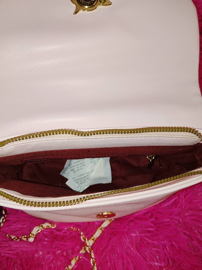 Tom And Jerry Pink Adjustable bag- original (Category: Luxury Bags & Wallets) located in Manila. Submitted by hisandherscloset2025 (Listing ID 1468463015, Image 3). Description: - Official Tom and Jerry gold metal plaque - Shiny finish with engraved cartoon character art - Detailed with four corner screw accents - Attached to a dark red fabric lining - Clean surface with clear lettering at the bottom - Fun and unique accessory for cartoon fans - 