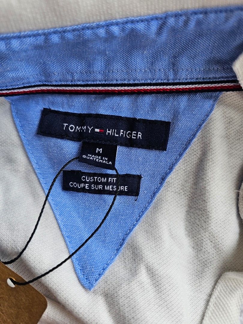 Tommy Hilfiger (Category: Tshirts & Polo Shirts ) located in Baguio. Submitted by kayeonlineshop (Listing ID 1468342872, Image 3). Description: -men's off-white or beige textured polo shirt featuring a classic collar, a button placket, and a small Tommy Hilfiger flag logo on the left chest -measurements included in the photos.