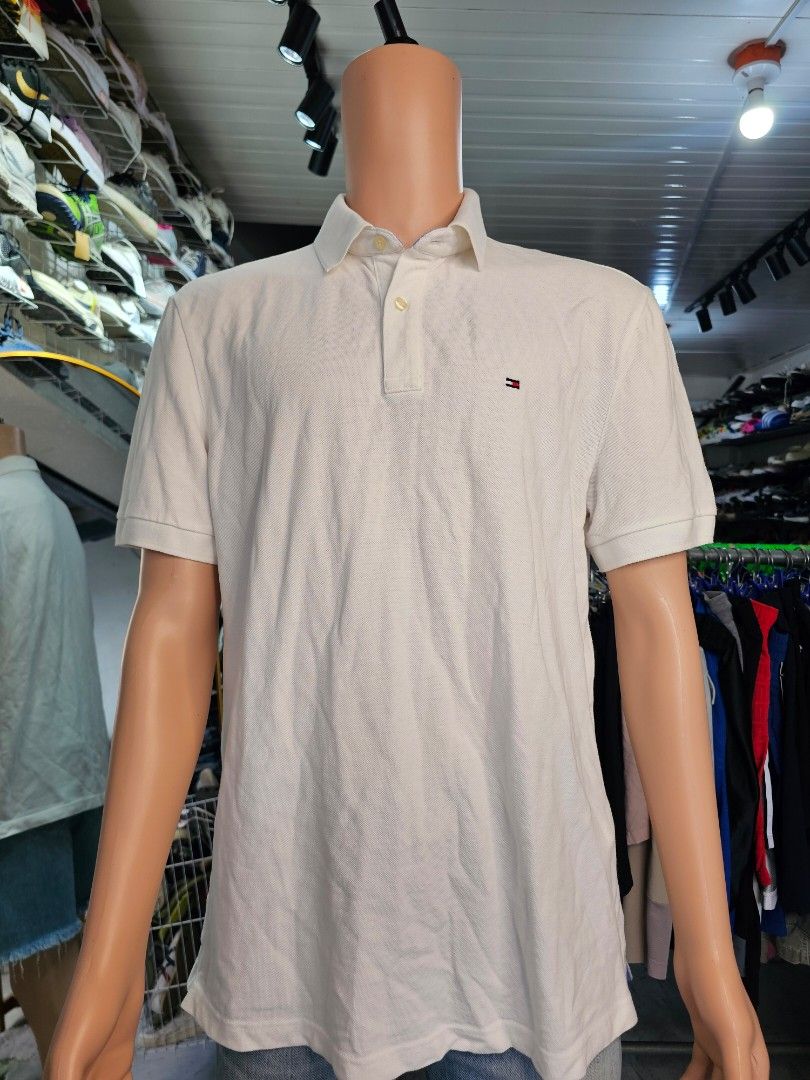 Tommy Hilfiger (Category: Tshirts & Polo Shirts ) located in Baguio. Submitted by kayeonlineshop (Listing ID 1468342872, Image 2). Description: -men's off-white or beige textured polo shirt featuring a classic collar, a button placket, and a small Tommy Hilfiger flag logo on the left chest -measurements included in the photos.