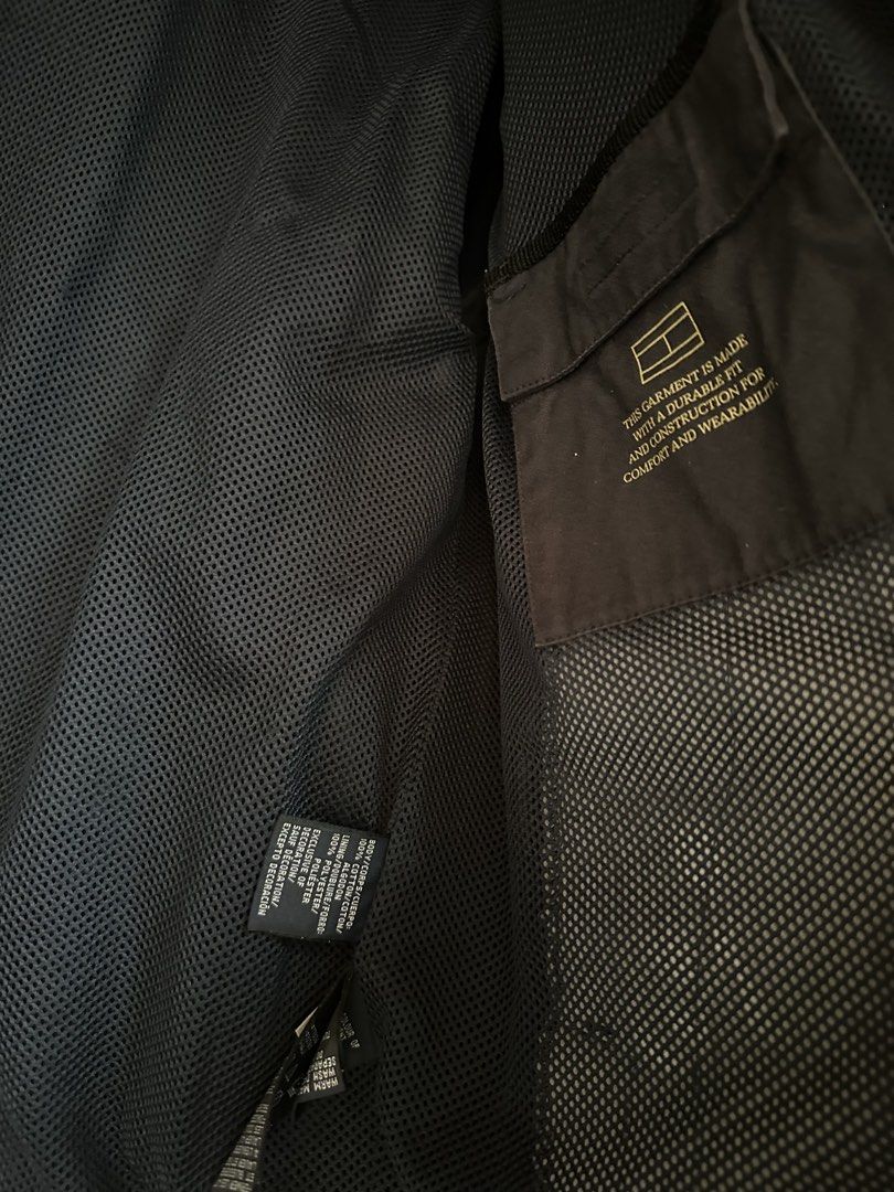 Tommy Hilfiger Harrington Jacket (Category: Coats, Jackets and Outerwear) located in Subic. Submitted by declutterbyshit (Listing ID 1468379131, Image 3). Description: - Brand: Tommy Hilfiger - Size: M 9/10 26x22 - Color: Dark Navy / Black - Material: Comfortable cotton shell with breathable mesh interior lining - Closure: Zip front with branded pull tab - Design: Classic white and blue striped collar lining, small embroidered flag logo on chest 