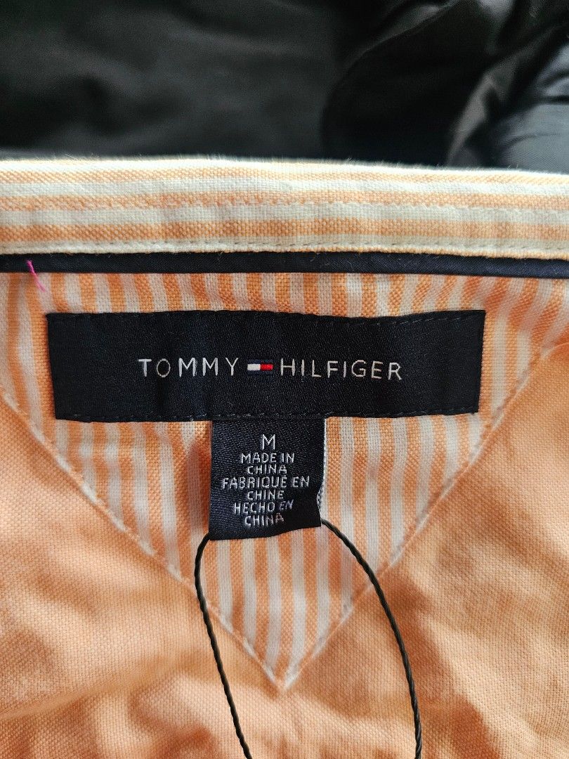 Tommy Hilfiger Shirt (Category: Formal Shirts) located in Baguio. Submitted by kayeonlineshop (Listing ID 1468299183, Image 3). Description: orange or peach-colored long-sleeve button-down dress shirt with a chest pocket and a small Tommy Hilfiger flag logo embroidery..