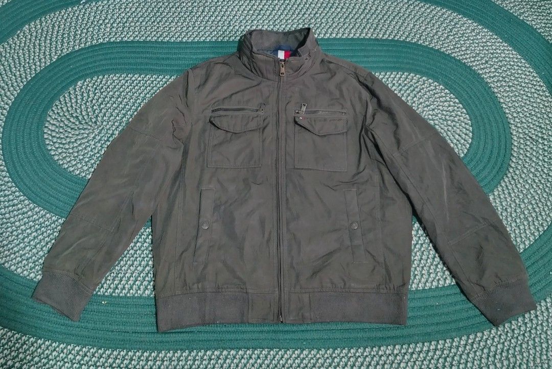 Tommy Hilfiger Water Resistant Wind Resistant Jacket Size L (Category: Coats, Jackets and Outerwear) located in Lucena. Submitted by thrifteditem (Listing ID 1468338355, Image 2). Description: - Brand: Tommy Hilfiger - Color: Dark Green - Size: Large - Features: Water resistant, wind resistant, full zip front - Pockets: Multiple functional pockets on chest and lower body - Details: Ribbed collar, cuffs, and hem for a snug fit - Perfect for: Casua
