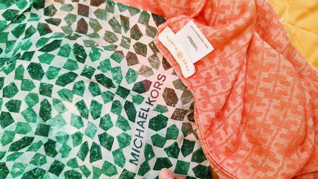 Tory Burch and Michael Kors Scarf Set (Category: Scarves) located in Manila. Submitted by anez06 (Listing ID 1468351762, Image 2). Description: - Bundle of 2 authentic designer scarves - Scarf 1: Coral pink Tory Burch monogram pattern, made in Italy, 67% viscose and 33% modal - Scarf 2: Green and white geometric mosaic pattern with Michael Kors branding - Both items come with original brand tags - Made with soft, premium fabrics - Versatile and s