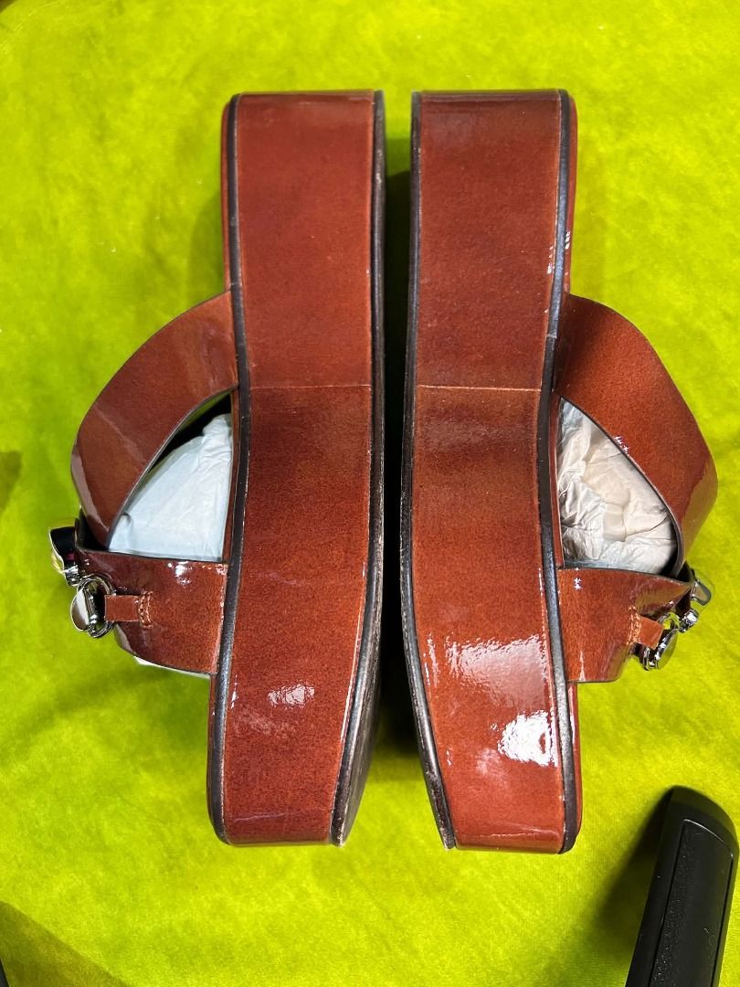 Tory Burch Jessa Platform Sandal. (Category: Sneakers & Footwear) located in Quezon City. Submitted by abk_storemandaluyong25 (Listing ID 1468448004, Image 3). Description: Product Details • Brand: Tory Burch • Model: Jessa Platform Sandal / Jessa Slide • Colorway: Russet Brown / Tan Patent Leather • Design Features: A prominent '90s-inspired platform wedge sole crafted in rich russet brown patent leather, highlighted by crisscross front straps t