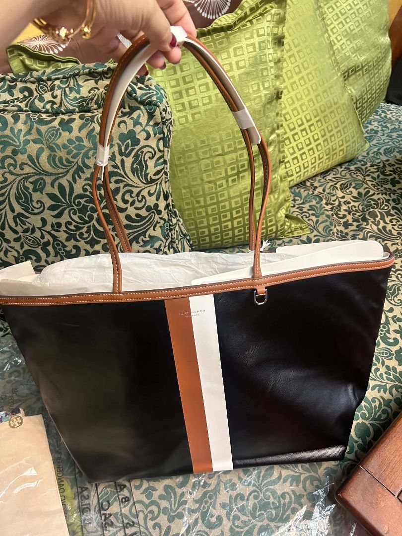 Tory Burch Perry Triple-Compartment Tote (Category: Luxury Bags & Wallets) located in Quezon City. Submitted by abk_storemandaluyong25 (Listing ID 1468454227, Image 3). Description: Product Details • Brand: Tory Burch • Model: Perry Stripe Triple-Compartment Tote • Colorway: Black with White and Luggage (Brown) Center Stripes • Materials: Durable textured coated canvas or Italian pebbled leather upper, with slim leather shoulder straps. • Design 