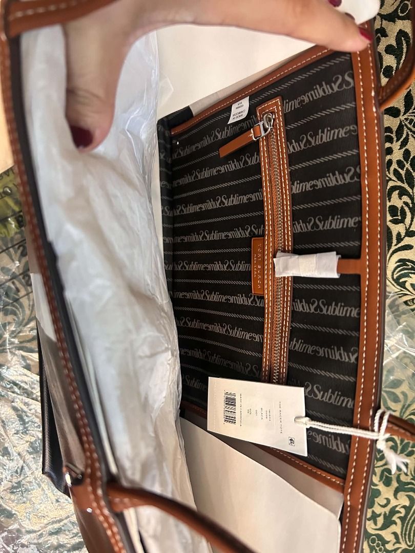 Tory Burch Perry Triple-Compartment Tote (Category: Luxury Bags & Wallets) located in Quezon City. Submitted by abk_storemandaluyong25 (Listing ID 1468454227, Image 2). Description: Product Details • Brand: Tory Burch • Model: Perry Stripe Triple-Compartment Tote • Colorway: Black with White and Luggage (Brown) Center Stripes • Materials: Durable textured coated canvas or Italian pebbled leather upper, with slim leather shoulder straps. • Design 