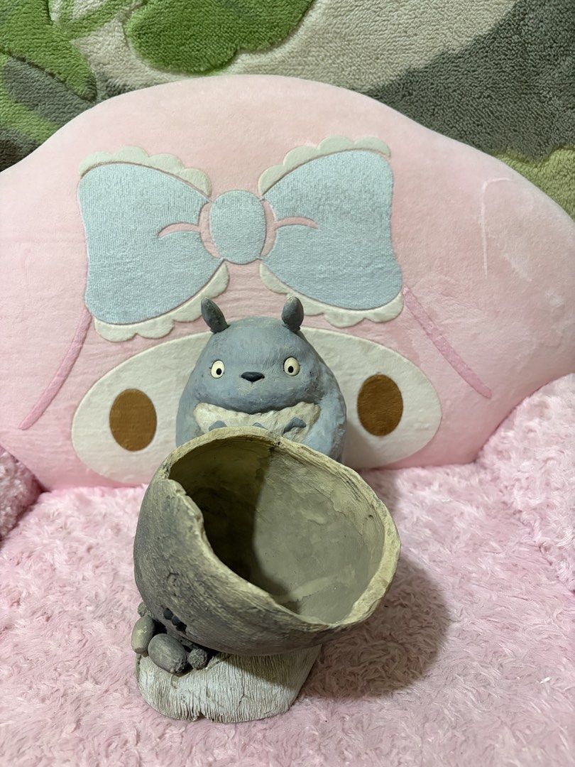 Totoro planter (Category: Pots & Planters) located in Naic. Submitted by rmcollectibles (Listing ID 1468437953, Image 1). Description: - Adorable Totoro figurine with a hollowed-out pot for small succulents or cacti - Made of durable grey resin with hand-painted details - Features a built-in drainage hole at the bottom - Minor scuff marks on the back and bottom (does not affect stability) - Stands securely on a flat base.