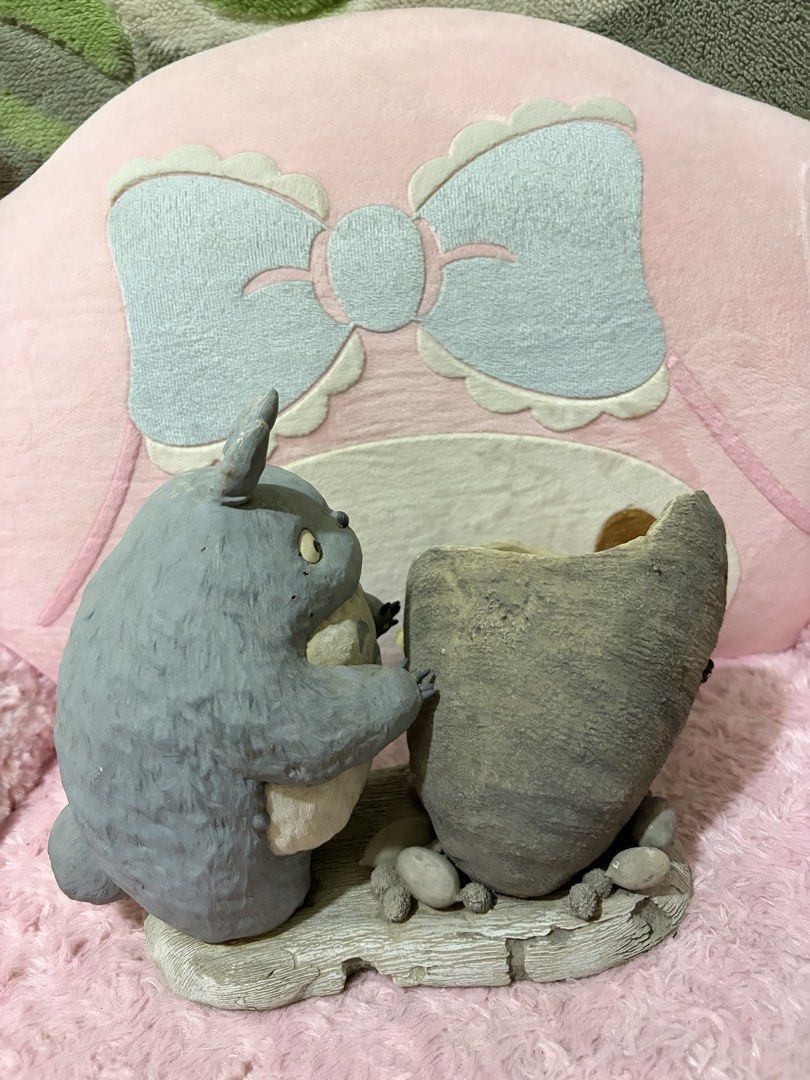 Totoro planter (Category: Pots & Planters) located in Naic. Submitted by rmcollectibles (Listing ID 1468437953, Image 3). Description: - Adorable Totoro figurine with a hollowed-out pot for small succulents or cacti - Made of durable grey resin with hand-painted details - Features a built-in drainage hole at the bottom - Minor scuff marks on the back and bottom (does not affect stability) - Stands securely on a flat base.