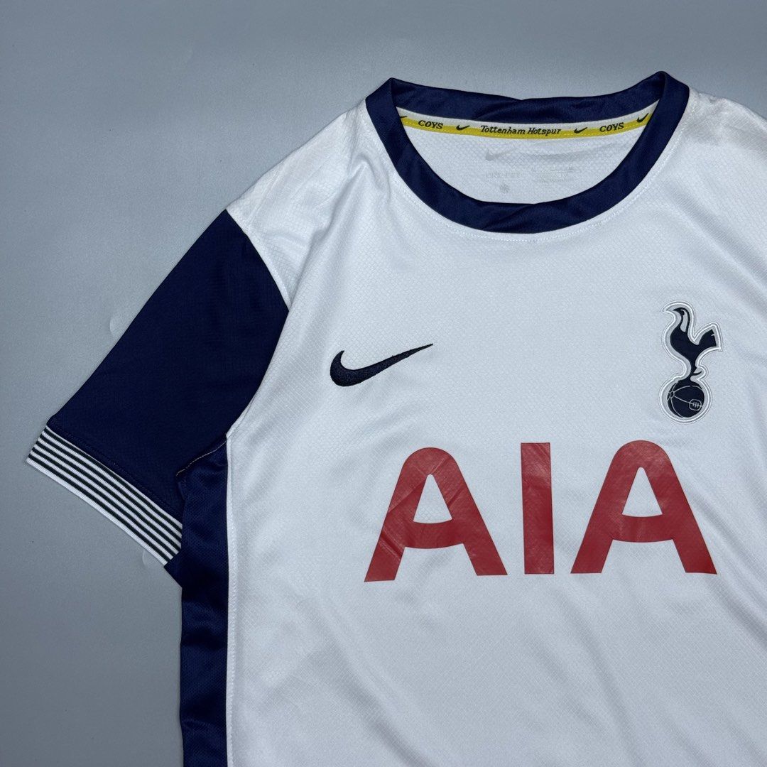 Tottenham Hotspur Nike Home Jersey (Category: Activewear) located in Kabacan. Submitted by rags2penny.phl (Listing ID 1468337554, Image 2). Description: Tottenham Hotspur home jersey from Nike. White base with dark navy sleeves and side panels. Red AIA sponsor logo on the front. Embroidered club crest and Nike swoosh. Yellow inner neck taping featuring Tottenham Hotspur and COYS text. Dri-FIT technology fabric. Size M tag on inner collar and engi