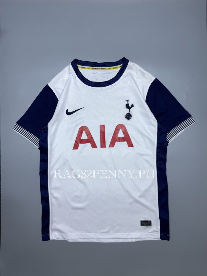 Tottenham Hotspur Nike Home Jersey (Category: Activewear) located in Kabacan. Submitted by rags2penny.phl (Listing ID 1468337554, Image 1). Description: Tottenham Hotspur home jersey from Nike. White base with dark navy sleeves and side panels. Red AIA sponsor logo on the front. Embroidered club crest and Nike swoosh. Yellow inner neck taping featuring Tottenham Hotspur and COYS text. Dri-FIT technology fabric. Size M tag on inner collar and engi