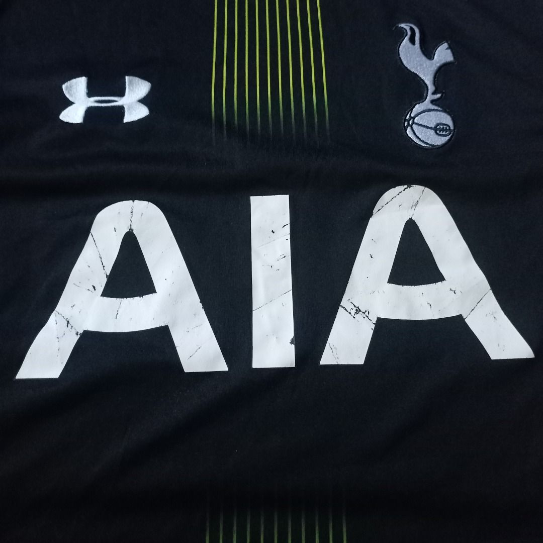 Tottenham Hotspur Under Armour Away Jersey (Category: Activewear) located in Cavite. Submitted by kurtgg.what (Listing ID 1468357970, Image 2). Description: Authentic Tottenham Hotspur away jersey by Under Armour Courier: J&T/Lalamove - Colorway: Black with striking neon yellow side panels and vertical gradient stripe - Features official AIA sponsor logo, club crest, and Under Armour branding - Standard short-sleeve athletic cut made from breatha