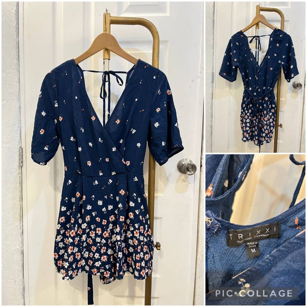 Trixxi Blue Floral Romper Size M (Category: Rompers) located in Quezon City. Submitted by chicberry (Listing ID 1468337480, Image 1). Description: - Brand: Trixxi Clothing Company - Size: Medium - Color/Pattern: Navy blue with white and pink floral print on the shorts - Neckline: V-neck with short sleeves - Details: Cute tie-back and adjustable built-in waist tie for a better fit - Condition: Brand new with tag attached.