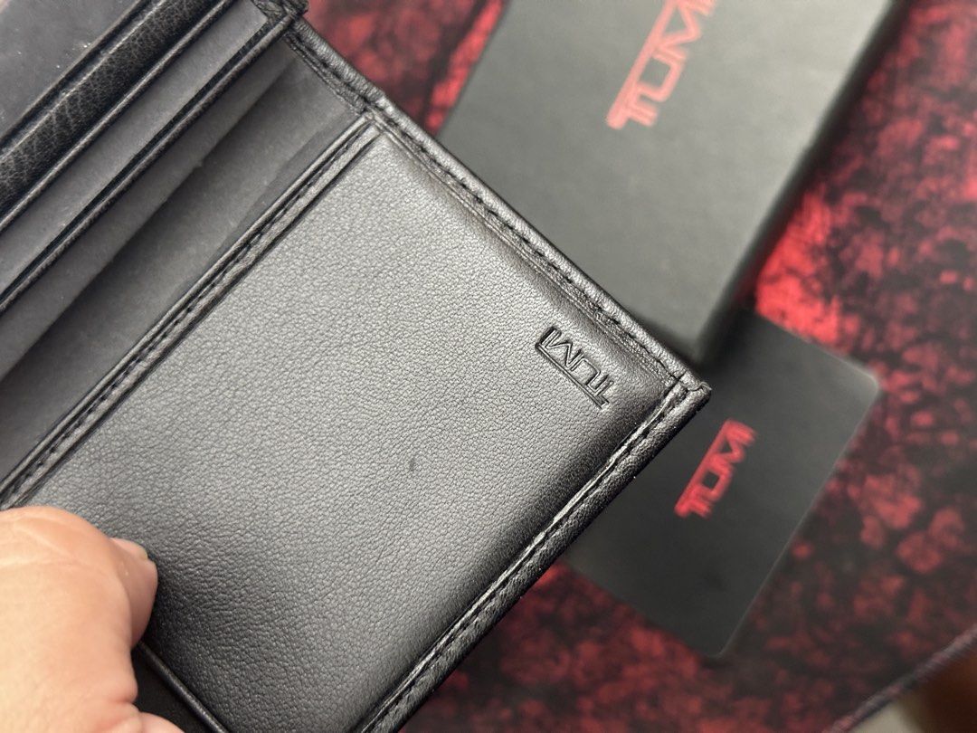 TUMI Black Leather Card Case Wallet with Box (Category: Wallets & Card Holders) located in Bustos. Submitted by theprelovedshopbulacan (Listing ID 1468330180, Image 3). Description: - Brand: TUMI - Material: Premium black leather - Inclusions: Original branded box and card - Features: Multiple interior card slots and clear ID window - Design: Compact fold with clean stitching and embossed logo branding - Condition: Excellent / Like new.