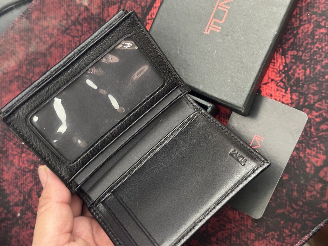 TUMI Black Leather Card Case Wallet with Box (Category: Wallets & Card Holders) located in Bustos. Submitted by theprelovedshopbulacan (Listing ID 1468330180, Image 2). Description: - Brand: TUMI - Material: Premium black leather - Inclusions: Original branded box and card - Features: Multiple interior card slots and clear ID window - Design: Compact fold with clean stitching and embossed logo branding - Condition: Excellent / Like new.