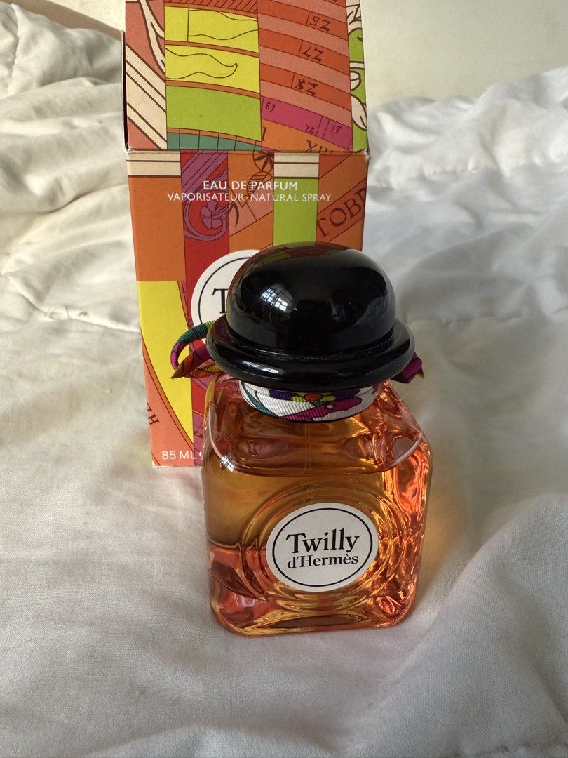 Twilly d'Hermès Eau de Parfum 85ml (Category: Fragrance & Deodorants) located in Batangas. Submitted by gaprelovedthings (Listing ID 1468358151, Image 3). Description: - Authentic Hermès Twilly Eau de Parfum - Generous 85ml bottle size (Natural Spray) - Barely used, liquid level is still very high - Comes with original colorful box packaging - Features signature black cap and iconic silk ribbon tied around the neck - Batch codes clearly visible o